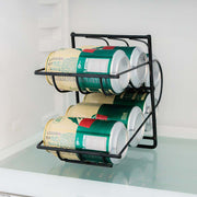 Dispensador de latas negro con latas en sus dos niveles dentro de una refrigeradora