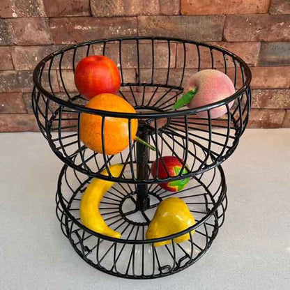 Frutero decorativo de dos niveles negro con frutas en sus dos canastas