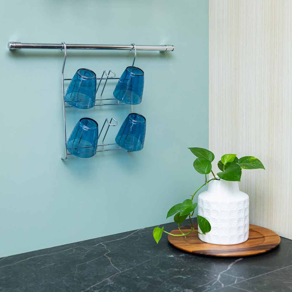 Porta vasos cromado para tubo con vasos azules, instalado sobre la encimera